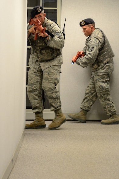 U.S. Air Force Tech. Sgts. Zeth Otto (left) and Matthew Martindell (right) with the 139th Security Forces Squadron, Missouri Air National Guard, search for an active shooter during an active shooter exercise at Rosecrans Air National Guard Base, Mo., July 25, 2013.  Active shooter exercises allow security forces Airmen the opportunity to prepare for a potential shooter on the base.  (U.S. Air National Guard photo by Tech. Sgt. Theo Ramsey/Released)