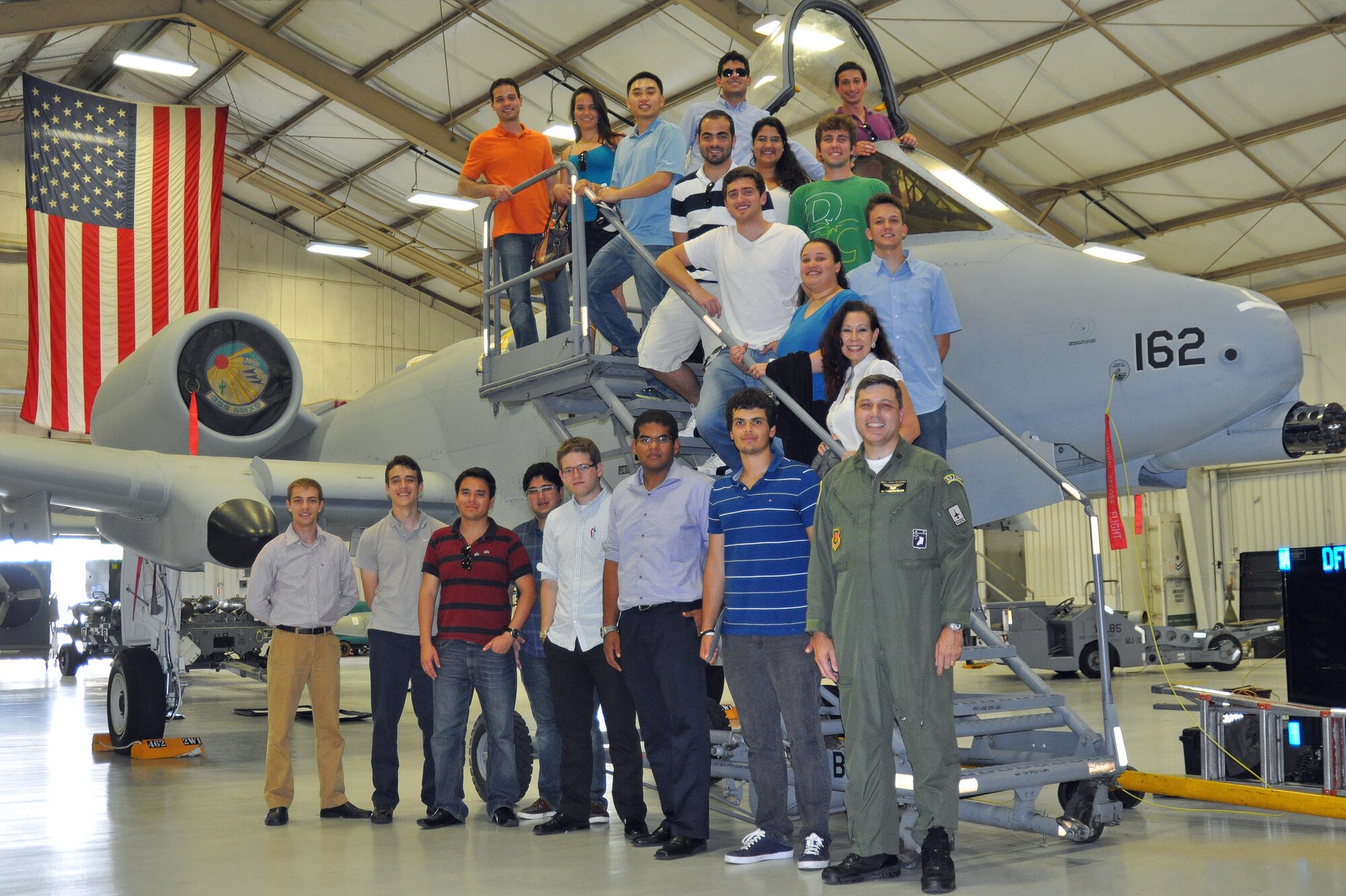 Graduate and doctoral engineering students from Brazil pose for a picture in front of a U.S. Air Force A-10 Thunderbolt II with Col. Paulo Vasconcellos, Brazilian Air Force liaison officer to Headquarters Twelfth Air Force (Air Forces Southern), during a tour of Davis-Monthan Air Force Base, July 24. The students were in Tucson, Ariz., visiting the nearby Raytheon Company as part of Brazil’s Science Without Borders program and requested the opportunity to visit D-M.  The A-10 is a close air support aircraft that has proven invaluable to the United States and its allies in operations including Desert Storm, Southern Watch, Provide Comfort, Desert Fox, Noble Anvil, Deny Flight, Deliberate Guard, Allied Force, Enduring Freedom and Iraqi Freedom. (U.S. Air Force photo/Capt. Jonathan Simmons)