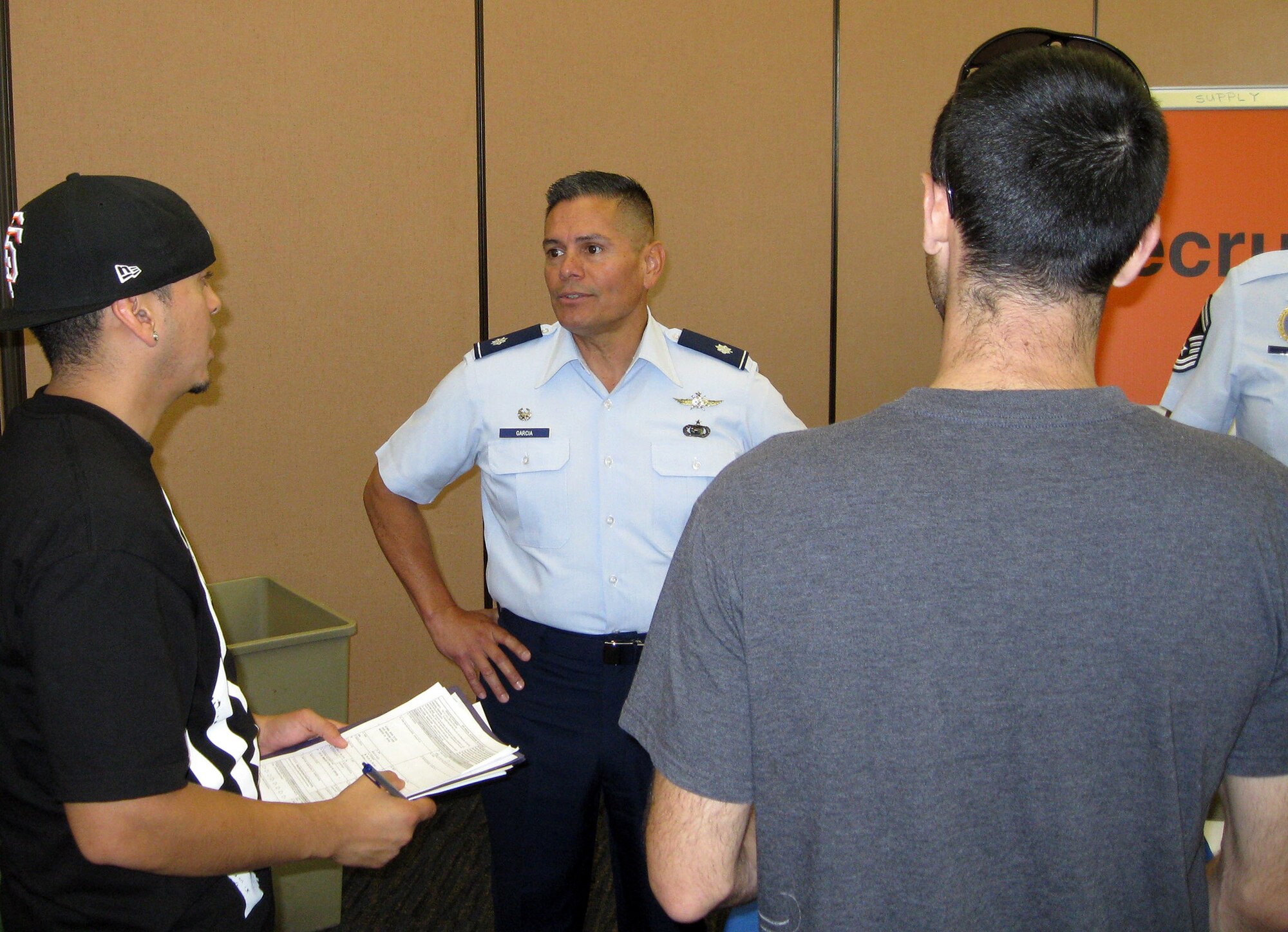 TRAVIS AIR FORCE BASE, Calif. -- Lt. Col. Roberto Garcia, Commander of the 38th Intelligence Squadron at Beale Air Force Base, Calif., talks with members of the IRR during a July 20 muster at Travis AFB. Garcia volunteered to support the 349th FSS team hosting the muster, and mentor those reporting for the day. (U.S. Air Force photo/Senior Master Sgt. Alexander Brown)