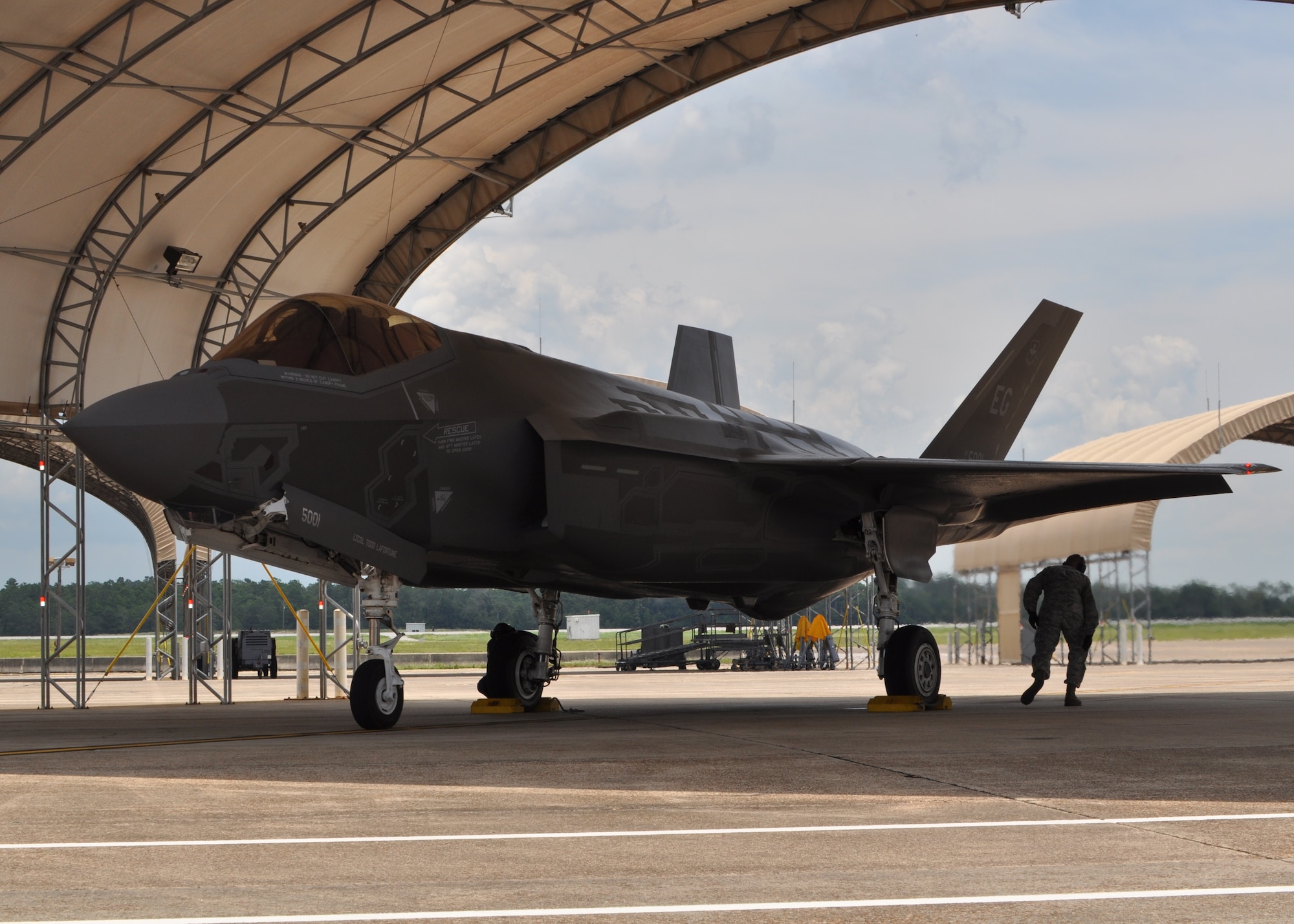 A crew chief from the 58th Aircraft Maintenance Unit, 33rd Fighter Wing, Eglin Air Force Base, Fla., performs post-flight procedures on the F-35A Lightning II aircraft July 1, 2013. The maintainers help to train up the next generation of fighter pilots by having aircraft available for the Air Force's daily flying operations at Eglin's Joint Strike Fighter Integrated Training Center. The sortie conducted was the wing commander's final flight to become a qualified F-35 instructor pilot. (U.S. Air Force photo/ Maj. Karen Roganov)  
