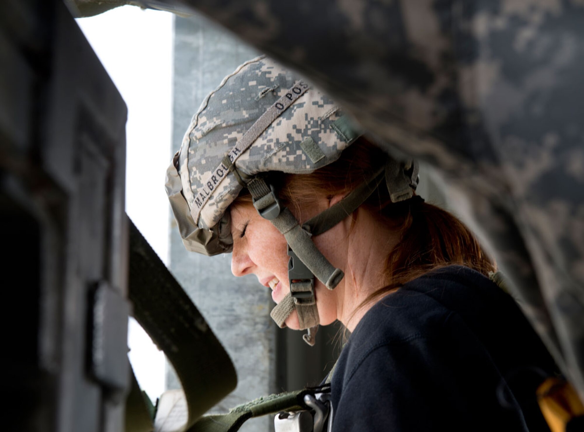 A spouse shuts her eyes before jumping from the Airborne Sustainment Training Area 34-foot tower. (U.S. Air Force photos/Airman 1st Class Austin Willhoit) (U.S. Air Force photo/Airman 1st Class Austin Willhoit)
