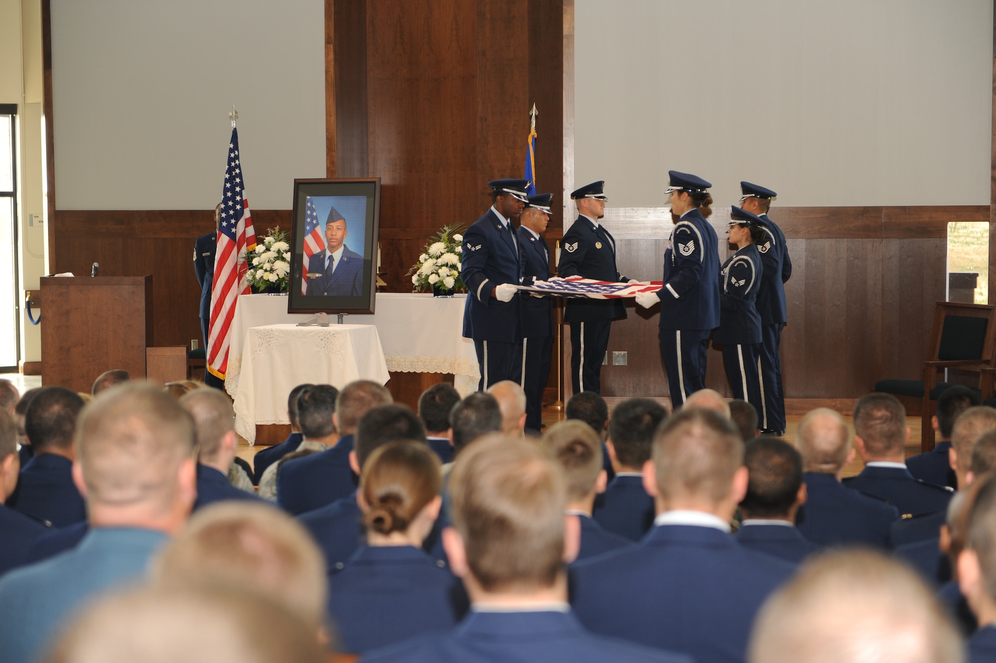 The 2nd Space Warning Squadron Honor Guard performs the flag-folding ceremony July 24, 2013, at the chapel on Buckley Air Force Base, Colo. The chapel was filled to standing-room-only capacity for Hargrove, a 2 SWS satellite systems operator, who was killed in an incident at 15th and Market Streets in downtown Denver July 13. (U.S. Air Force photo by Senior Airman Marcy Glass/Released)
