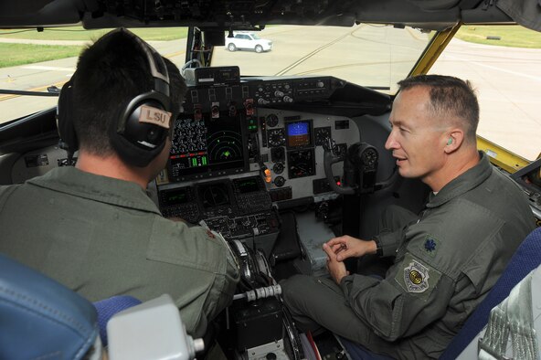 (Left) Maj. Scot Stewart, 22nd Operations Group aircraft commander, describes to Lt. Col. Eugene Croft, 22nd OG deputy commander, the upgrades that have been installed in the prototype KC-135 Stratotanker that they are in July 22, 2013, at McConnell Air Force Base, Kan. Some of the upgrades in block 45 include analog gauges that have been replaced with a digital monitor and a new auto-pilot system. (U.S. Air Force photo/Airman 1st Class Jose L. Leon)
