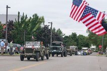HANSCOM AIR FORCE BASE, Mass. – Base personnel, along with friends and family, lined the streets to wave American flags and show their appreciation to recent deployers during the Hanscom Heroes Homecoming parade July 25. The parade was followed by a picnic in Memorial Park that recognized deployers and their families for outstanding service and commitment. (U.S. Air Force photo by Rick Berry)
