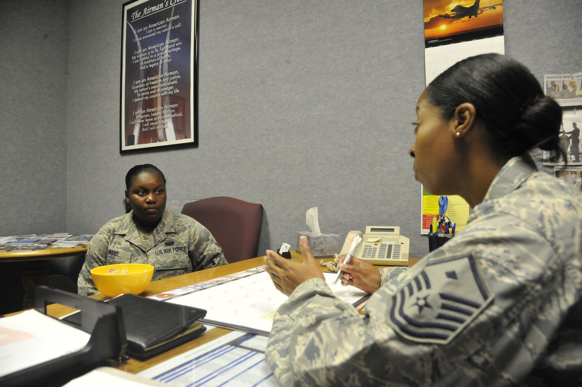 Master Sgt. Lafoundra Thompson, 509th Operations Group first sergeant, assists Airman 1st Class Tamila Reid, 509th Operation Support Squadron combat crew communications apprentice, with a personal situation at Whiteman Air Force Base, Mo., July 23, 2013. First sergeants play a key role in helping their Airmen with any situation that is brought to their attention. They also strive to encourage Airmen and keep the Whiteman mission rolling. (U.S. Air Force photo by Airman 1st Class Keenan Berry/Released)