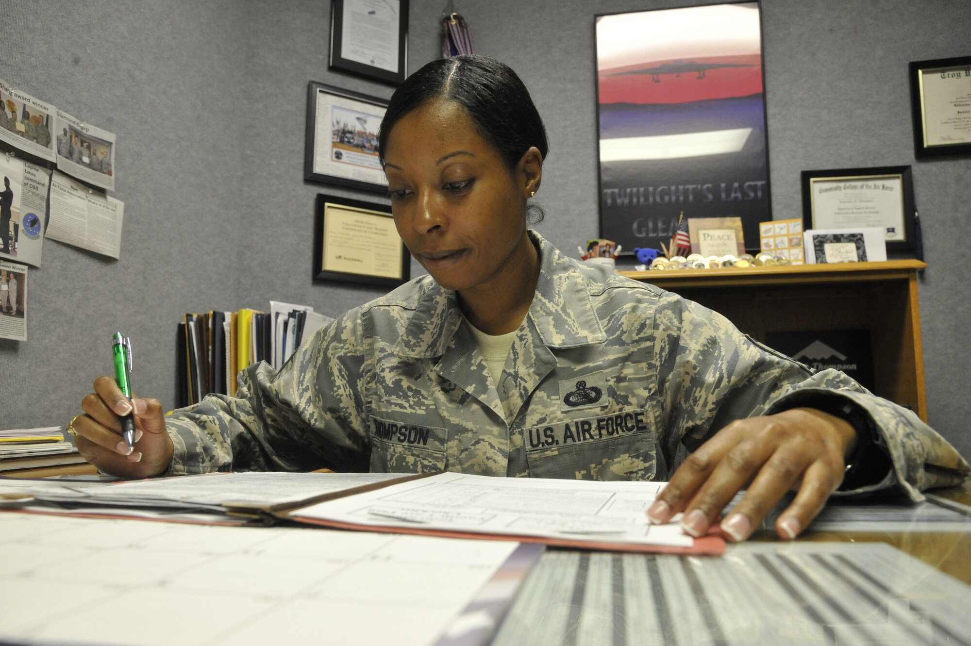 Master Sgt. Lafoundra Thompson, 509th Operations Group first sergeant, reviews a family care plan at Whiteman Air Force Base, Mo., July 16, 2013. First sergeants review family care plans and powers of attorney quarterly to make sure they are current and realistic. (U.S. Air Force photo by Airman 1st Class Keenan Berry/Released)