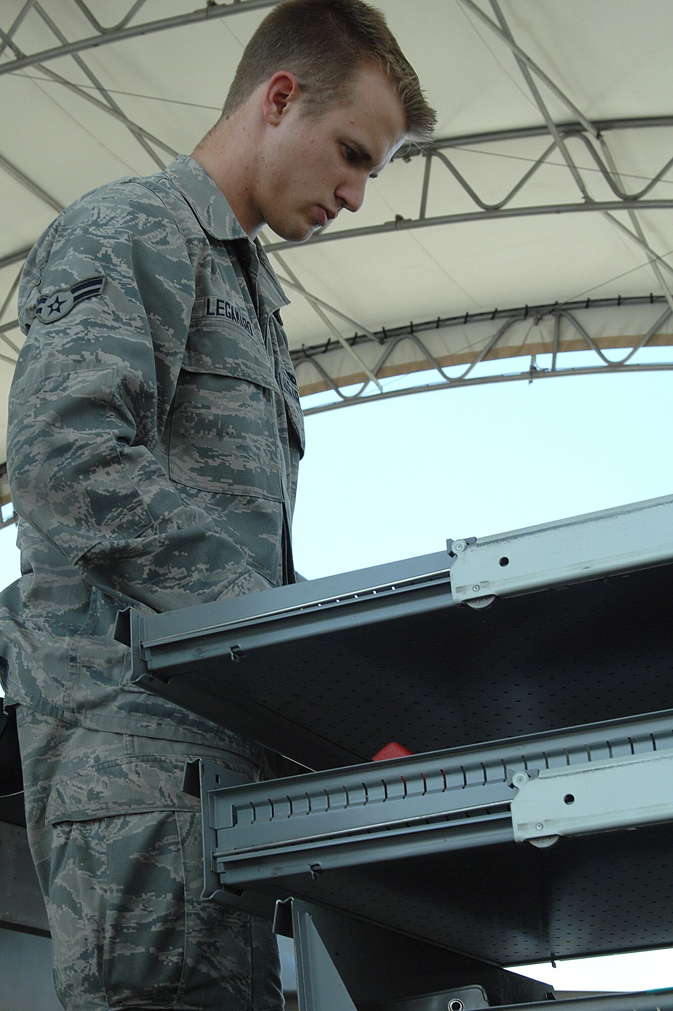 U.S. Air Force Airman 1st Class Casey Legamaro, 4th Aircraft Maintenance Squadron, 335th Aircraft Maintenance Unit weapons load crew member, organizes his team’s toolbox before beginning a load crew of the quarter competition at Seymour Johnson Air Force Base, N.C., July 19, 2013.  The crews were given only a few minutes after an open ranks inspection to organize their tools before the competition began.  (U.S. Air Force photo by Airman 1st Class Brittain Crolley/Released)