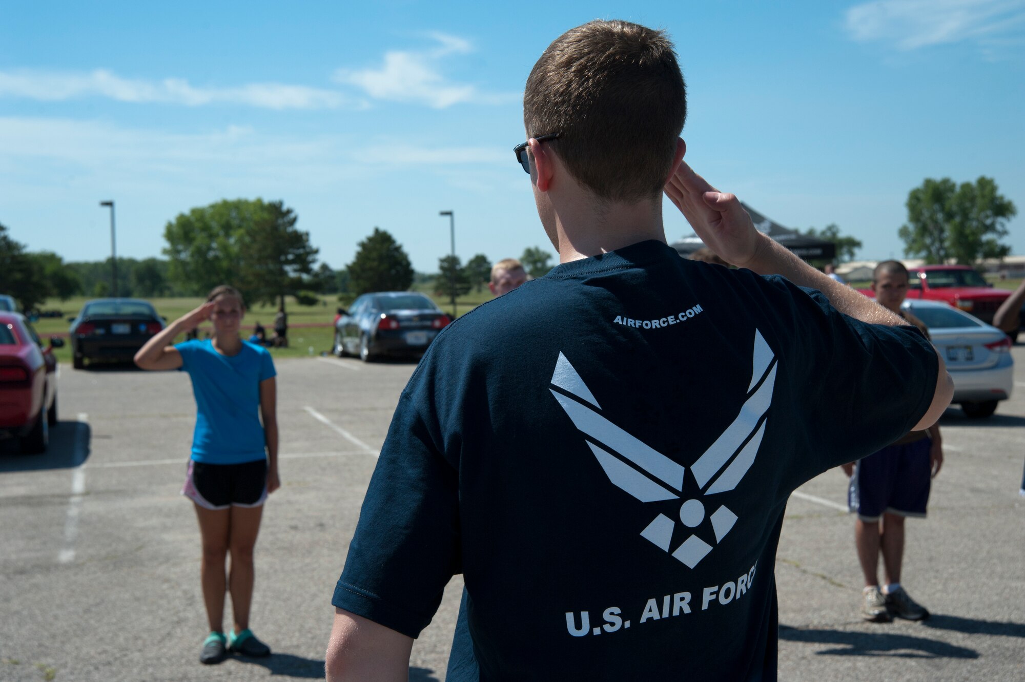 An Airman helps teach a group of recruits in the Delayed Entry Program how to salute during a DEP event July 20, 2013, at McConnell Air Force Base, Kan. More than 80 recruits from across a two-state area were given a brief class on drill and ceremony as part of the activities put together by the recruiters of the 349th Recruiting Squadron D-flight. (U.S. Air Force photo/Airman 1st Class Victor J. Caputo)