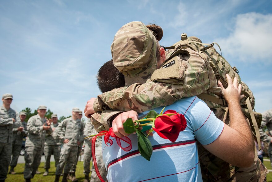 U.S. Air Force Staff Sgt. Christine Schairer (right) embraces U.S. Army Warrant Officer Alan Harwell after he proposed to her during an 822nd Base Defense Squadron deployment return at Moody Air Force Base, Ga., July 24, 2013. Schairer was one of 110 Airmen from the 822nd BDS returning from a six-month deployment to Bagram Airfield, Afghanistan. (U.S. Air Force photo by Senior Airman Jarrod Grammel/Released)

