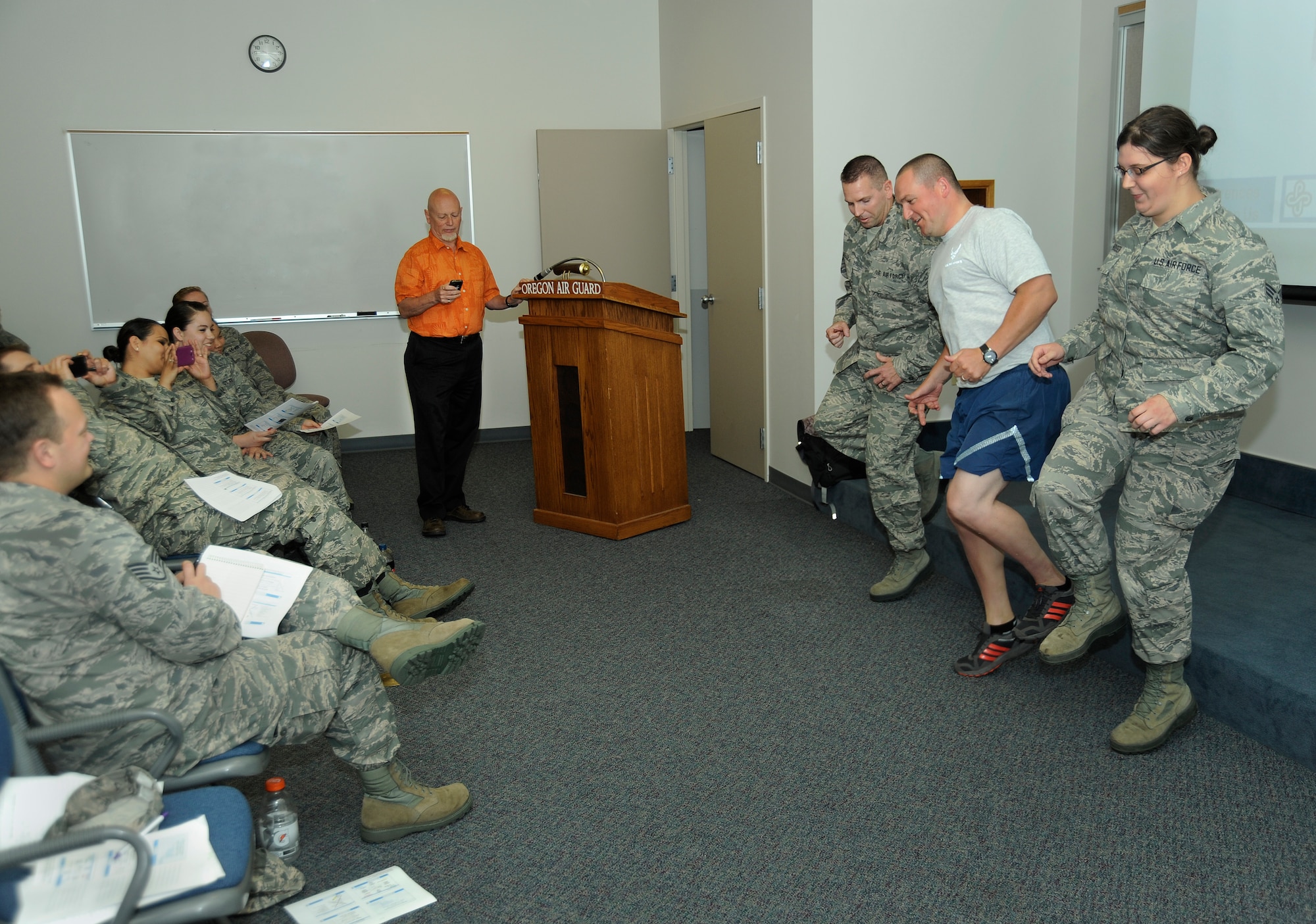 Airmen from the 142nd Fighter Wing Forces Support Squadron, preform a multitasking exercise as part of a discussion presentation by Dr. Allen Cabelly, a professor in Human Resource Management and Leadership at Portland State University. The lecture was part of a training session during the Unit Training Assembly, July 14, 2013, at the Portland Air National Guard Base, Ore. (Air National Guard photo by Tech. Sgt. John Hughel, 142nd Fighter Wing Public Affairs)