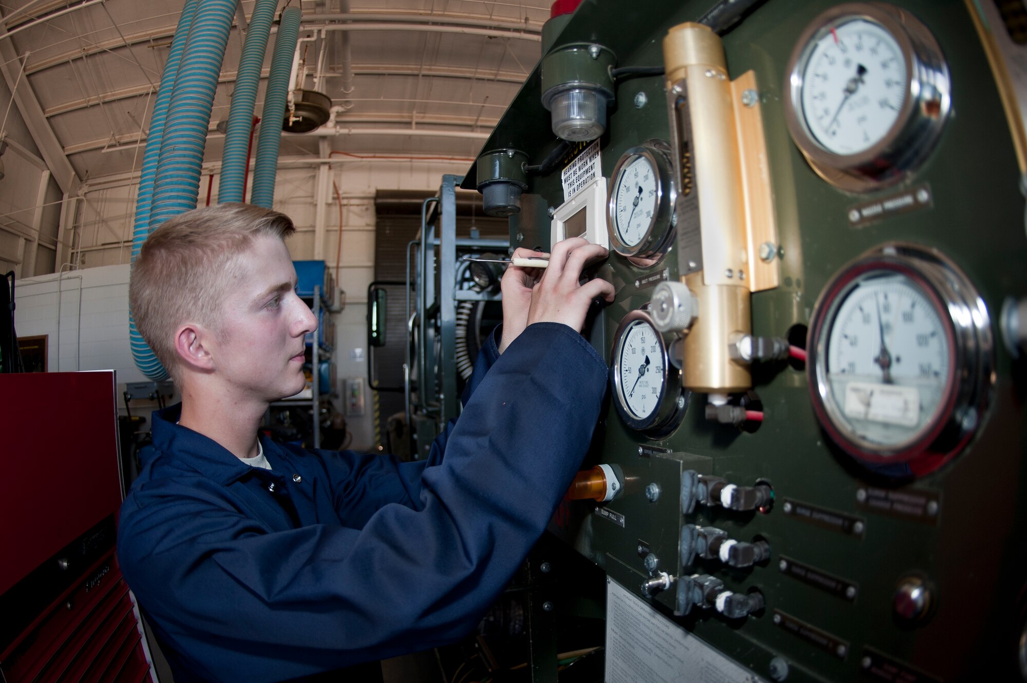 ALTUS AIR FORCE BASE, Okla. – Airman Tanner Peterson, 97th Logistics Readiness Squadron fire truck and refueling maintenance shop mechanic, checks the calibration of a R-12 refueling vehicle’s gauges during a routine maintenance inspection inside the vehicle maintenance shop, July 23. The calibration check is completed annually to ensure all Air Force equipment is compliant with federal fuel standards and regulations. (U.S. Air Force photo by Senior Airman Dillon Davis/Released)