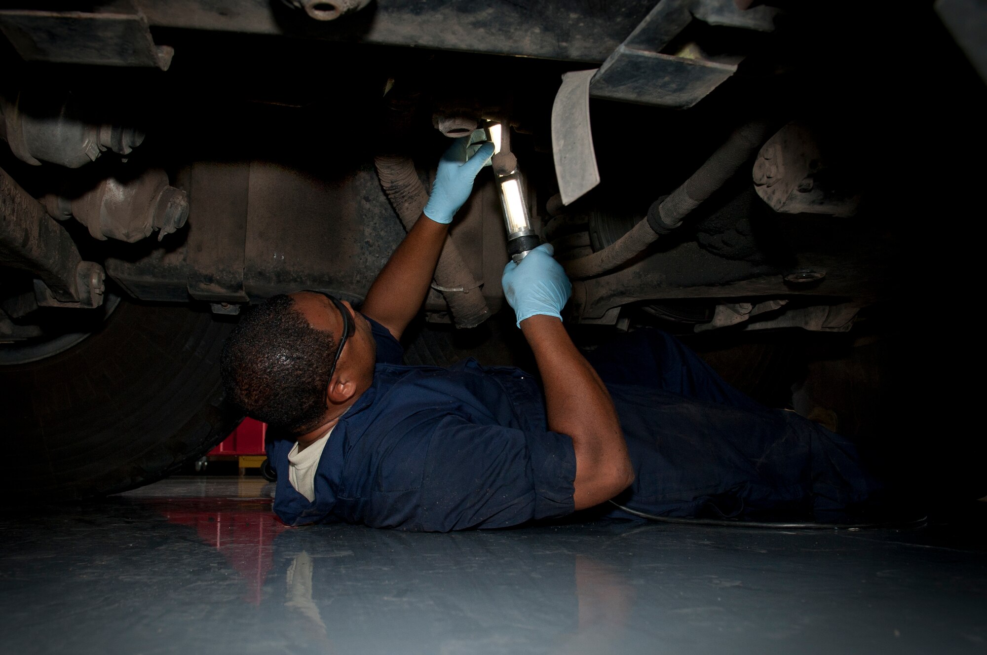ALTUS AIR FORCE BASE, Okla. – Staff Sgt. Benjamin Jones, 97th Logistics Readiness Squadron fire truck and refueling maintenance shop mechanic, searches for an air line underneath a P-23 crash truck during a preventative maintenance inspection inside the vehicle maintenance shop, July 23. The shop’s mission is to maintain 44 refueling vehicles and fire trucks to ensure constant training and mission readiness. (U.S. Air Force photo by Senior Airman Dillon Davis/Released)