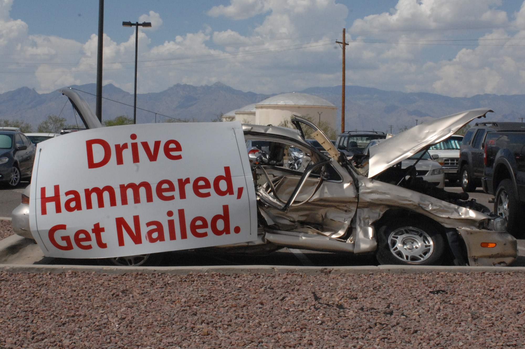 A car sits in the 755th Aircraft Maintenance Squadrons parking lot representing a drunk driving accident at Davis-Monthan Air Force Base, Ariz., July 15, 2013. The car is part of the squadron's campaign to bring awareness to the effects of drunk driving and help prevent similar incidents. (U.S. Air Force photo by Airman 1st Class Betty Chevalier/Released)