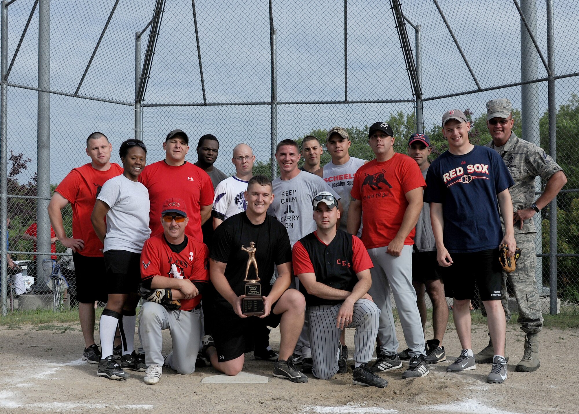 Members of the 319th Civil Engineer Squadron celebrate winning the intramural softball championship, July 22, 2013, on Grand Forks Air Force Base, N.D. The 319th CES defeated the 319th Communications Squadron 4-2. (U.S. Air Force photo/Airman 1st Class Ashley Nicole Taylor)