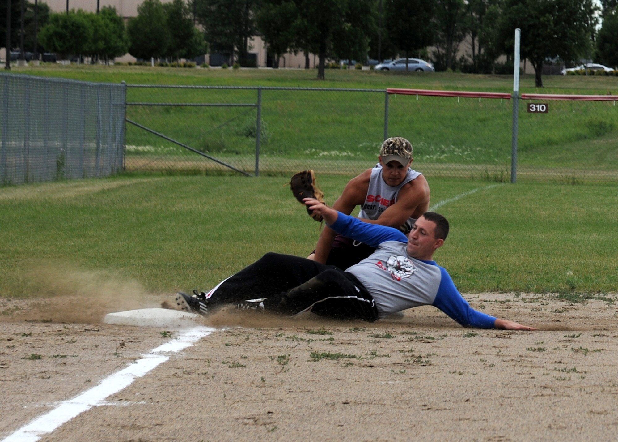 2nd Lt. Steven Cooney, 319th Communications Squadron, gets tagged out by Airman 1st Class Jacob Neeb, 319th Civil Engineer Squadron, during an intramural softball championship game, July 22, 2013, on Grand Forks Air Force Base, N.D. The 319th CES won the championship game with a final score of 4-2. (U.S. Air Force photo/Airman 1st Class Ashley Nicole Taylor)