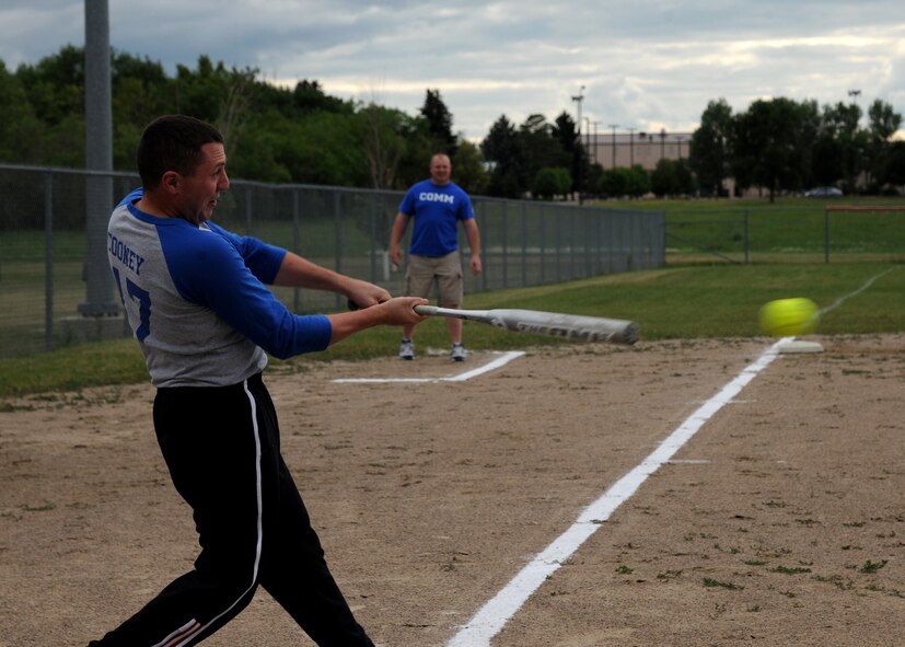 2nd Lt. Steven Cooney, 319th Communications Squadron flight commander, swings the bat during an intramural softball championship game, July 22, 2013, on Grand Forks Air Force Base, N.D. The 319th CS tied up the game in the bottom of the seventh inning making the score 2-2, but lost in the eighth inning 4-2. (U.S. Air Force photo/Airman 1st Class Ashley Nicole Taylor)