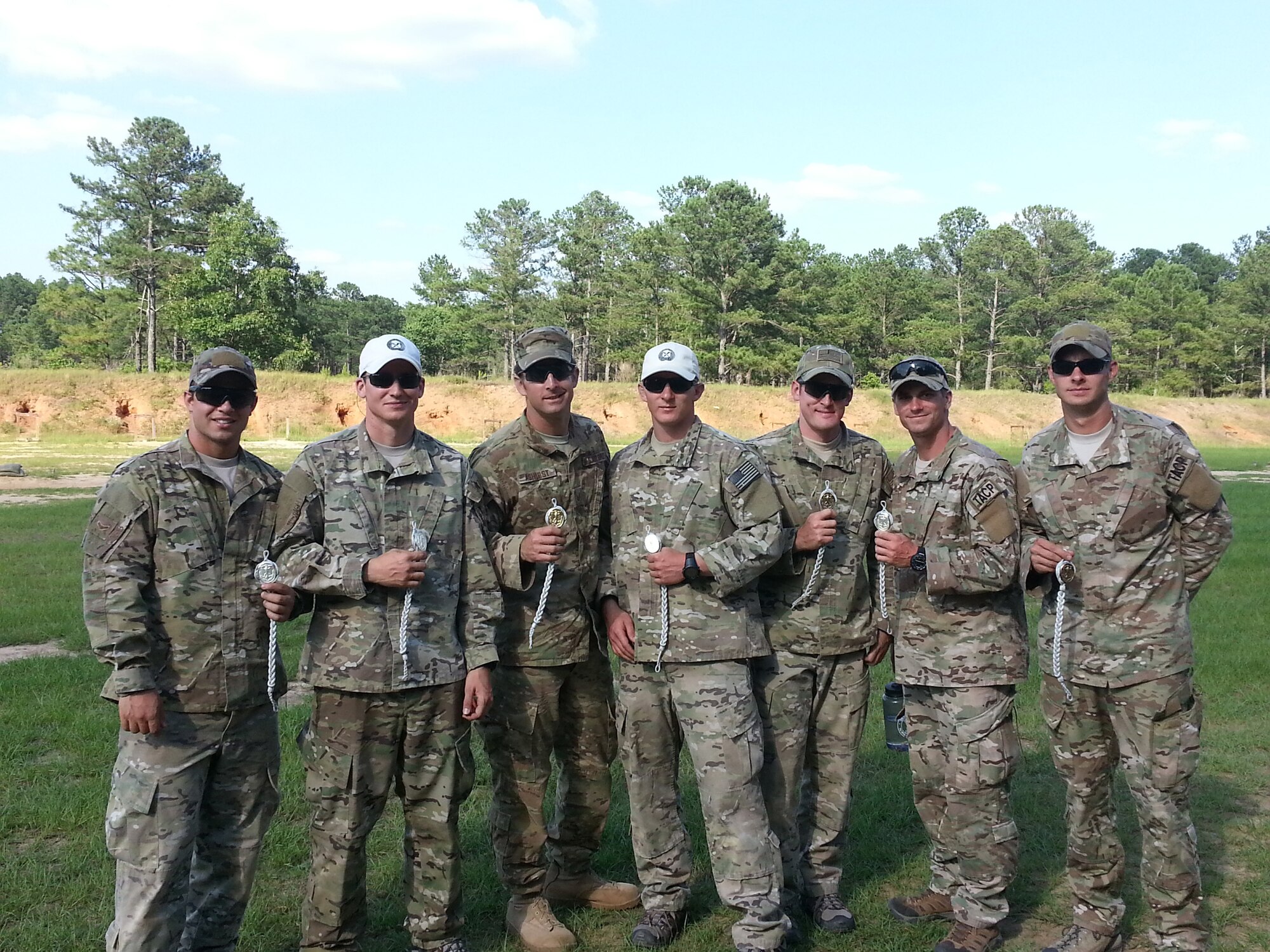 Airmen from the 165th Air Support Operations Squadron hold awards after participating in the German shooting proficiency test June 21, 2013 at Ft. Gordon Army Base near Augusta, Ga. A total of seven medals were earned including one gold, two silvers, and four bronze. (U.S. Air National Guard photo/released)