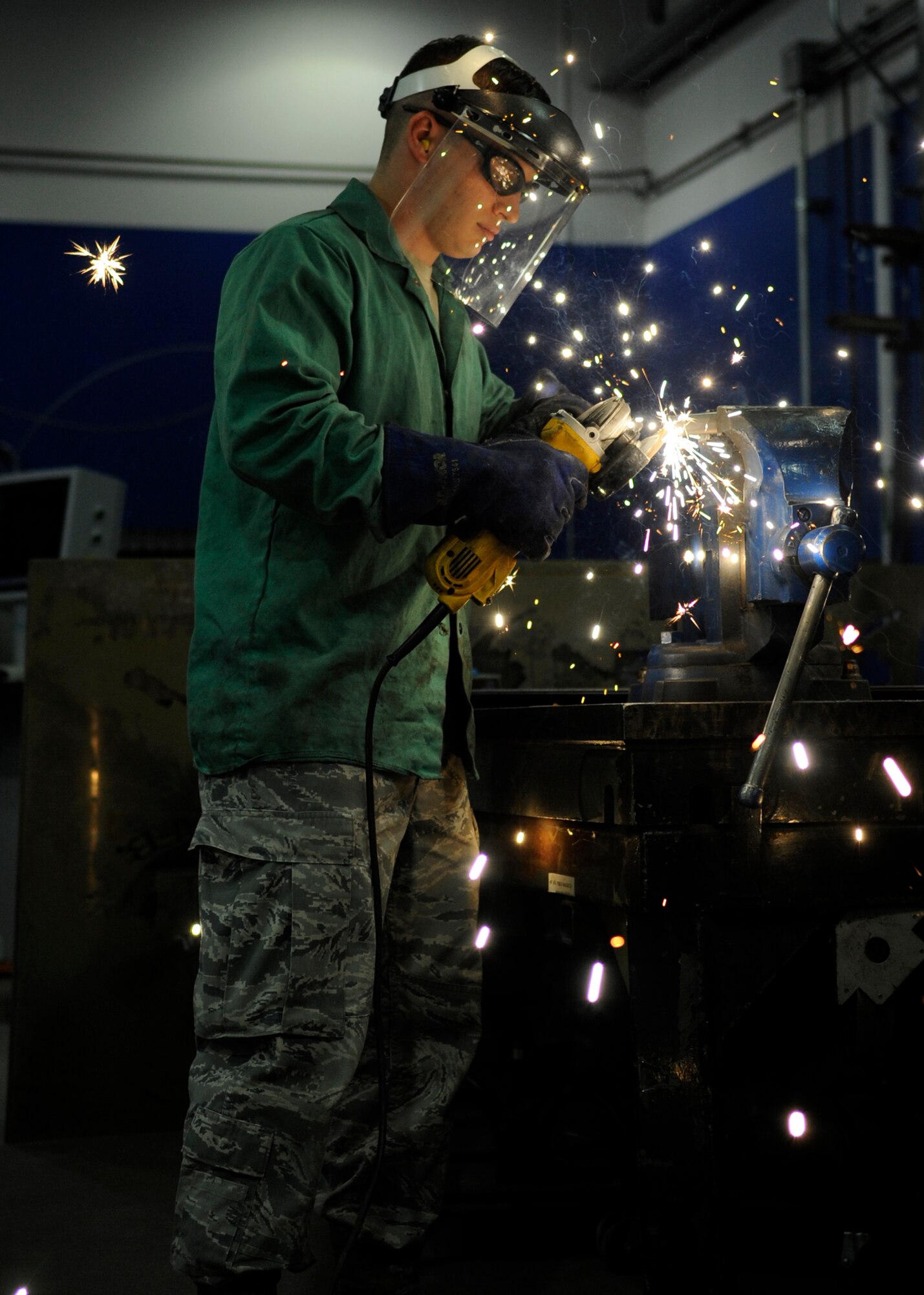U.S. Air Force Senior Airman Robert Mason, 354th Maintenance Squadron metals technology journeyman, grinds a piece of titanium while fabricating a part for an F-16 Fighting Falcon at Eielson Air Force Base, Alaska, July 22, 2013. Metals tech Airmen use practically any metal to fabricate parts and tools for machinery base wide. (U.S. Air Force Senior Airman Shawn Nickel/Released)