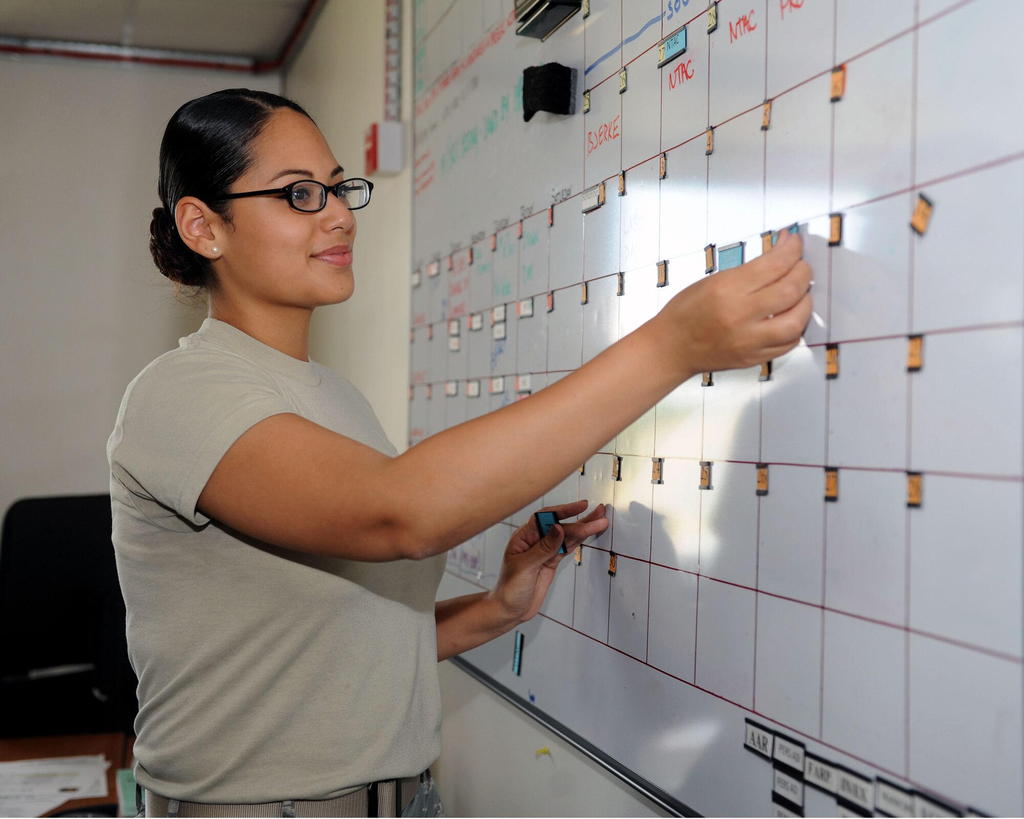 Staff Sgt. Kristal Lane, 67th Operations Squadron NCO in charge of Squadron Aviation Resource Management from Chicago, makes changes to an operations schedule for her office July 25, 2013, on RAF Mildenhall, England. Lane was chosen for the Square D Spotlight because of her incredible work ethic, which exemplifies the core value of Service Before Self. (U.S. Air Force photo by Airman 1st Class Preston Webb/Released)