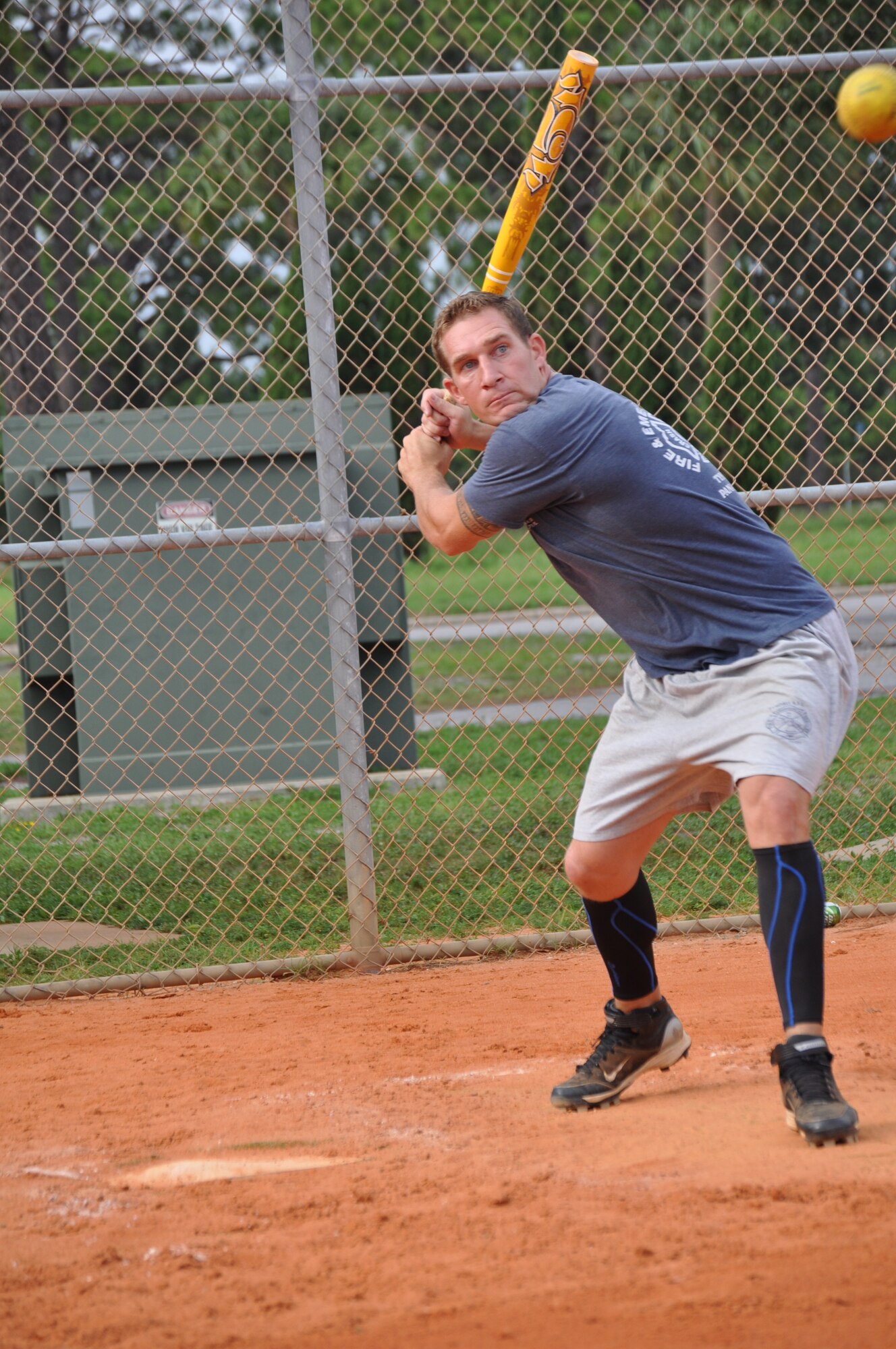 Airman 1st Class Cody Marshall, 325th Civil Engineer Squadron firefighter, keeps his eye on the ball during softball practice. The Jacksonville, Ill., native spent several years playing baseball and battling back from serious injuries before deciding to trade in his baseball bat for a fire ax. He will soon head to Texas to start training camp with the U.S. Air Force Softball Team. (U.S. Air Force by Ashley M. Wright)