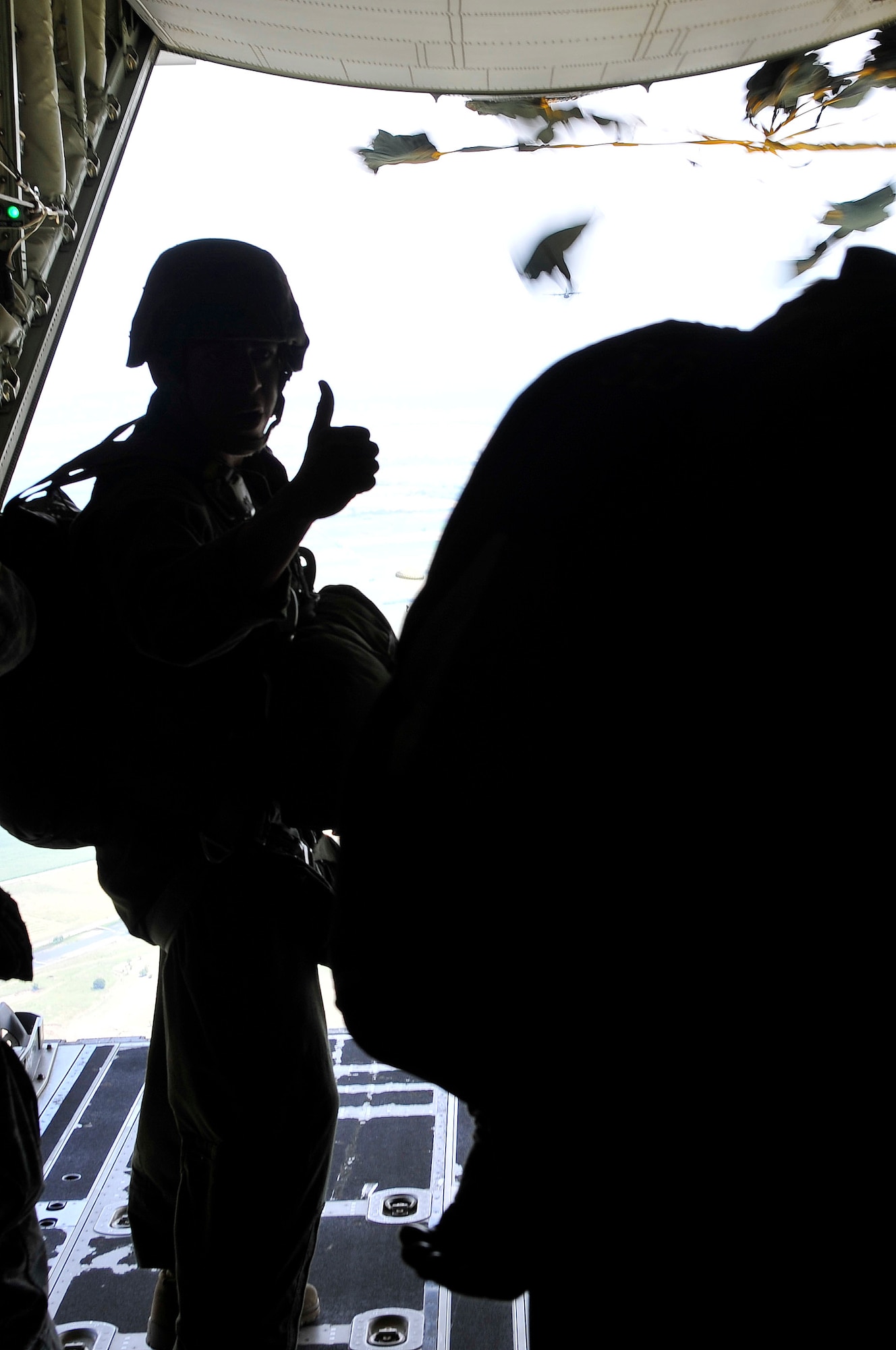 A Jumpmaster signals a successful pass during an airdrop, July 18, 2013, Plovdiv, Bulgaria. Jumpmasters are responsible for the safety of the paratroopers on their aircraft and ensuring they are dropped on the correct drop zone. (U.S. Air Force photo/Airman 1st Class Trevor Rhynes)