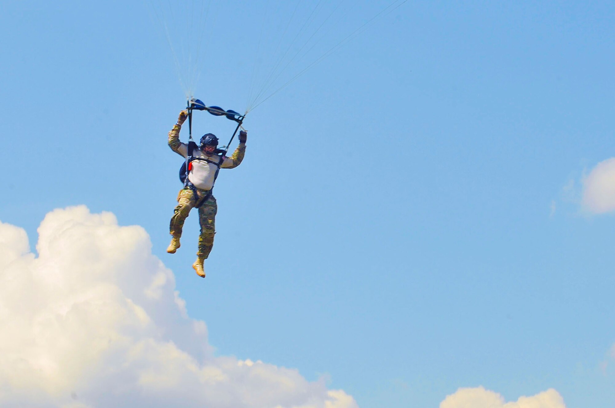 Master Sgt. Mitch Braddock, U.S. Air Forces in Europe and Air Forces Africa free fall jumpmaster, glides to the ground during a flying training deployment, July 17, 2013, Plovdiv, Bulgaria. Jumpmasters are responsible for the safety of the paratroopers on their aircraft and ensuring they are dropped on the correct drop zone. (U.S. Air Force photo/Airman 1st Class Trevor Rhynes)