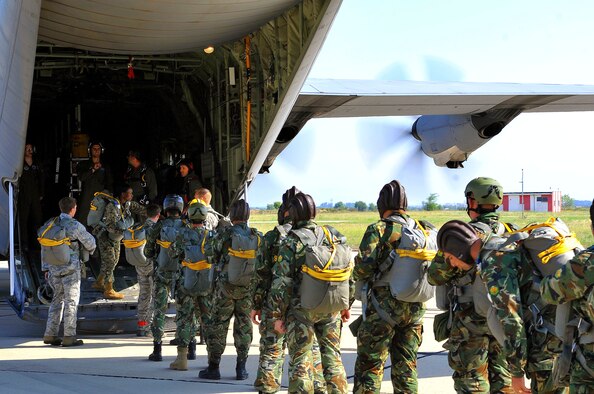 Bulgarian paratroopers board a C-130J Super Hercules prior to a wing exchange jump, July 17, 2013, Plovdiv, Bulgaria. American and Bulgarian paratroopers exchanged parachutes for the opportunity to conduct a wing exchange at the end of Thracian Summer. (U.S. Air Force photo/Airman 1st Class Trevor Rhynes)