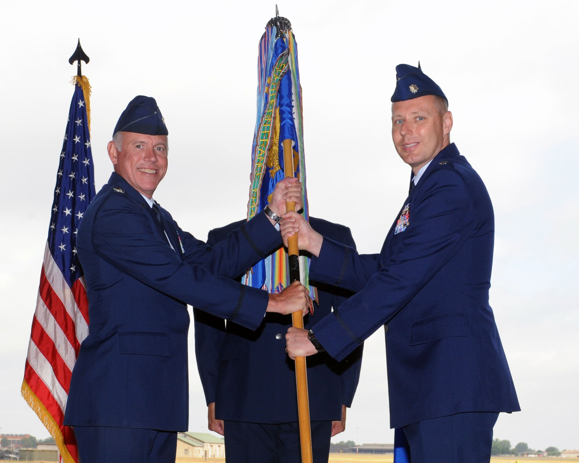 From left, Col. Russell Mammoser, 55th Operations Group commander, Offutt Air Force Base, Neb., hands the 95th Reconnaissance Squadron guidon to Lt. Col. Vincent Zaleski, incoming 95th RS commander, during the change of command ceremony July 25, 2013, on RAF Mildenhall, England. Zaleski  served as Director of Operations for the 95th RS from October of 2012 to July of 2013. (U.S. Air Force photo by Airman 1st Class Preston Webb/Released)