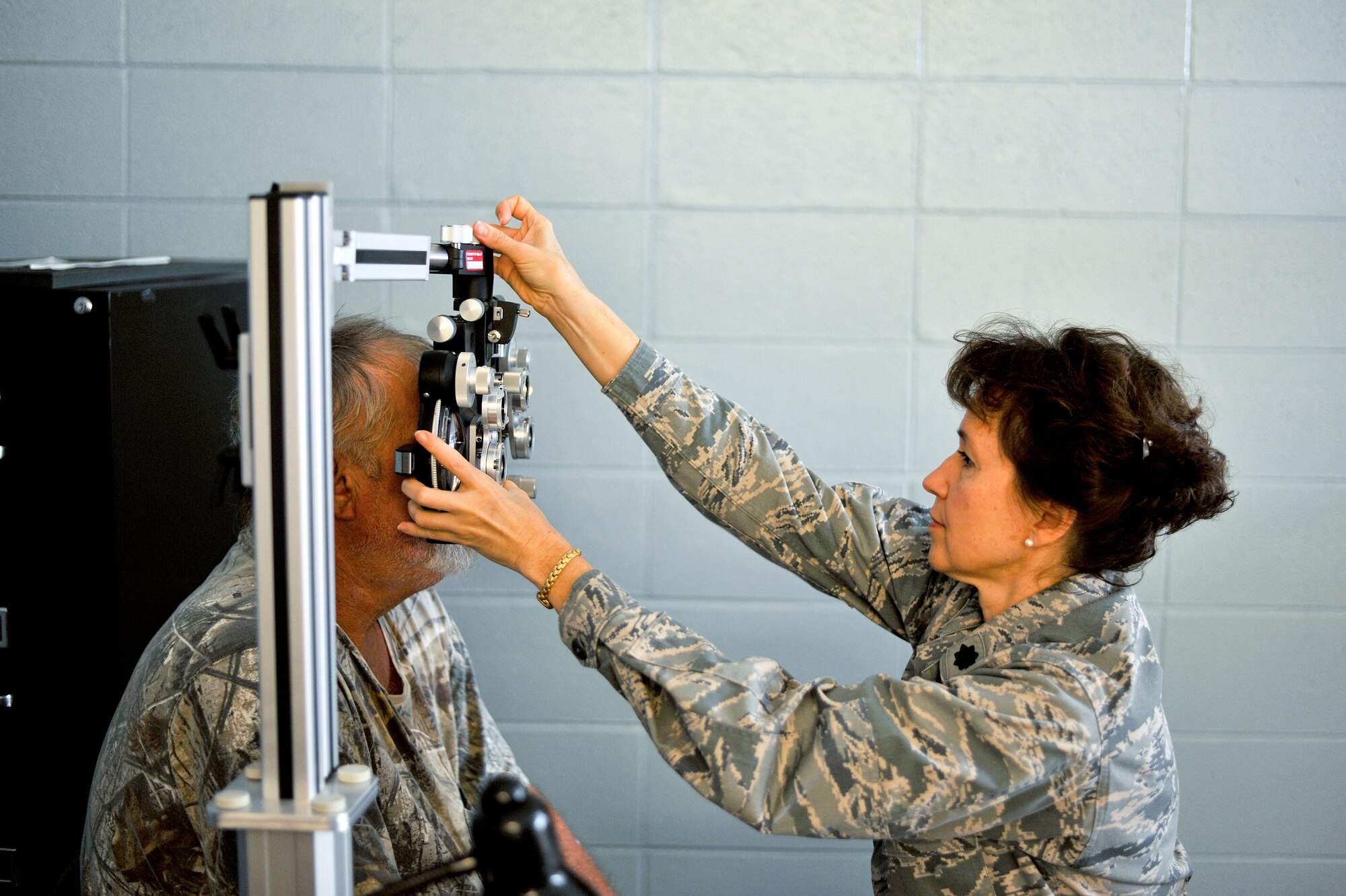Lt. Col. Julie Preston, an optometrist with the 180th Fighter Wing, Ohio Air National Guard, conducts a vision test July 16, 2013, at Martin Middle School in Martin, Tenn. Preston and about 130 service members from the Air National Guard, Naval Reserves and the Army came together in the West Tenn. Community to provide free medical care as part of Innovative Readiness Training in support of the two-week “Hope of Martin” health fair. Throughout Hope of Martin, the medical team had provided over 1,000 pairs of glasses to members of the Martin and surrounding communities. Air National Guard photo by Master Sgt. Beth Holliker (Released).