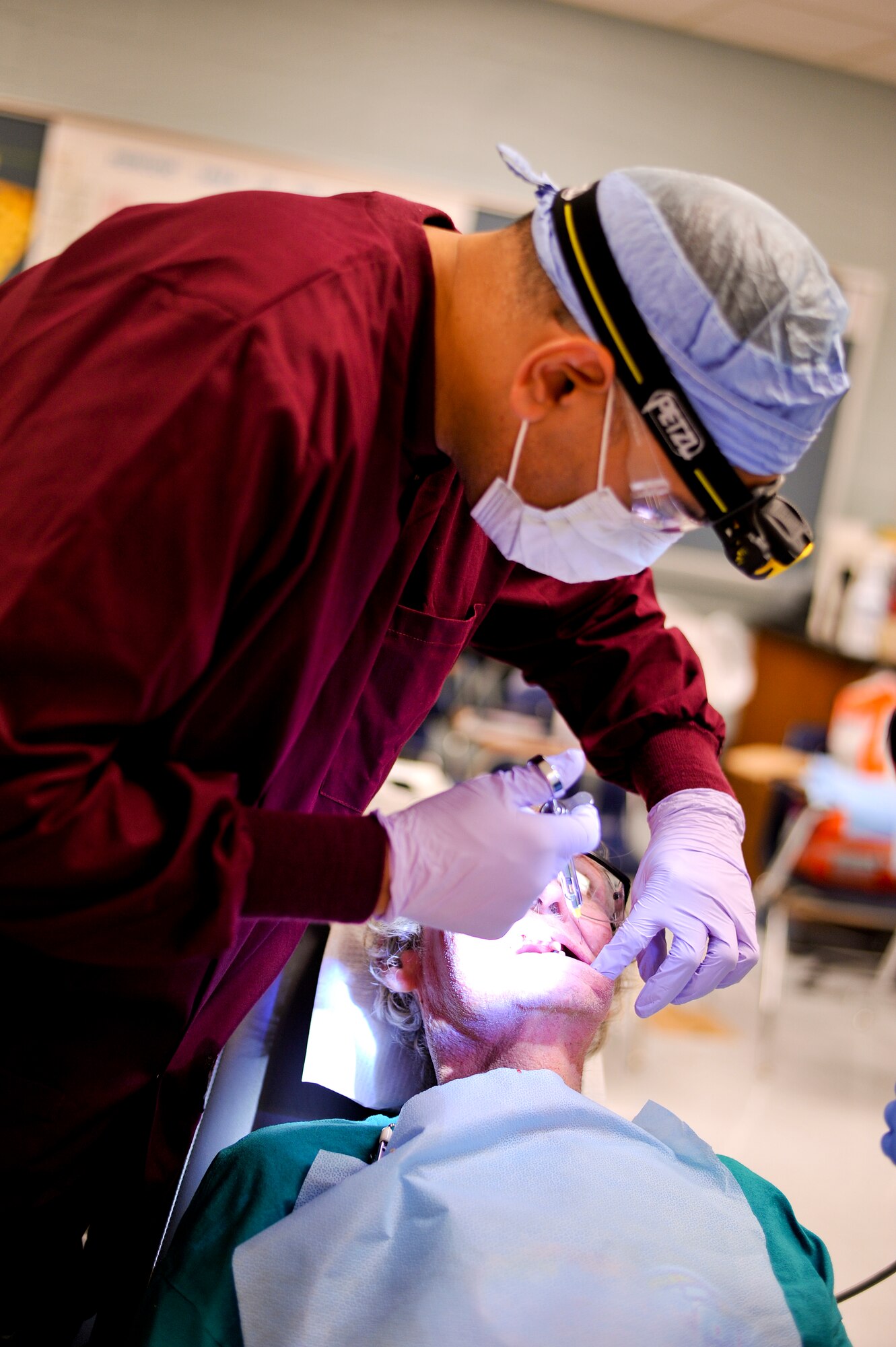 Lt. Cmdr. Ritesh Radadia, a U.S. Naval Reserve dentist preps Edward Hicks, a resident of nearby Dresden, Tenn., for a second dental procedure in two weeks. Hicks visited Hope of Martin all but two days over the two-week event in order to see providers. On top of receiving a comprehensive optical exam and a new pair of glasses, also produced on-site, Hicks also had multiple dental procedures which included the extraction of 30 teeth badly in need of repair. Air National Guard photo by Master Sgt. Beth Holliker (Released).