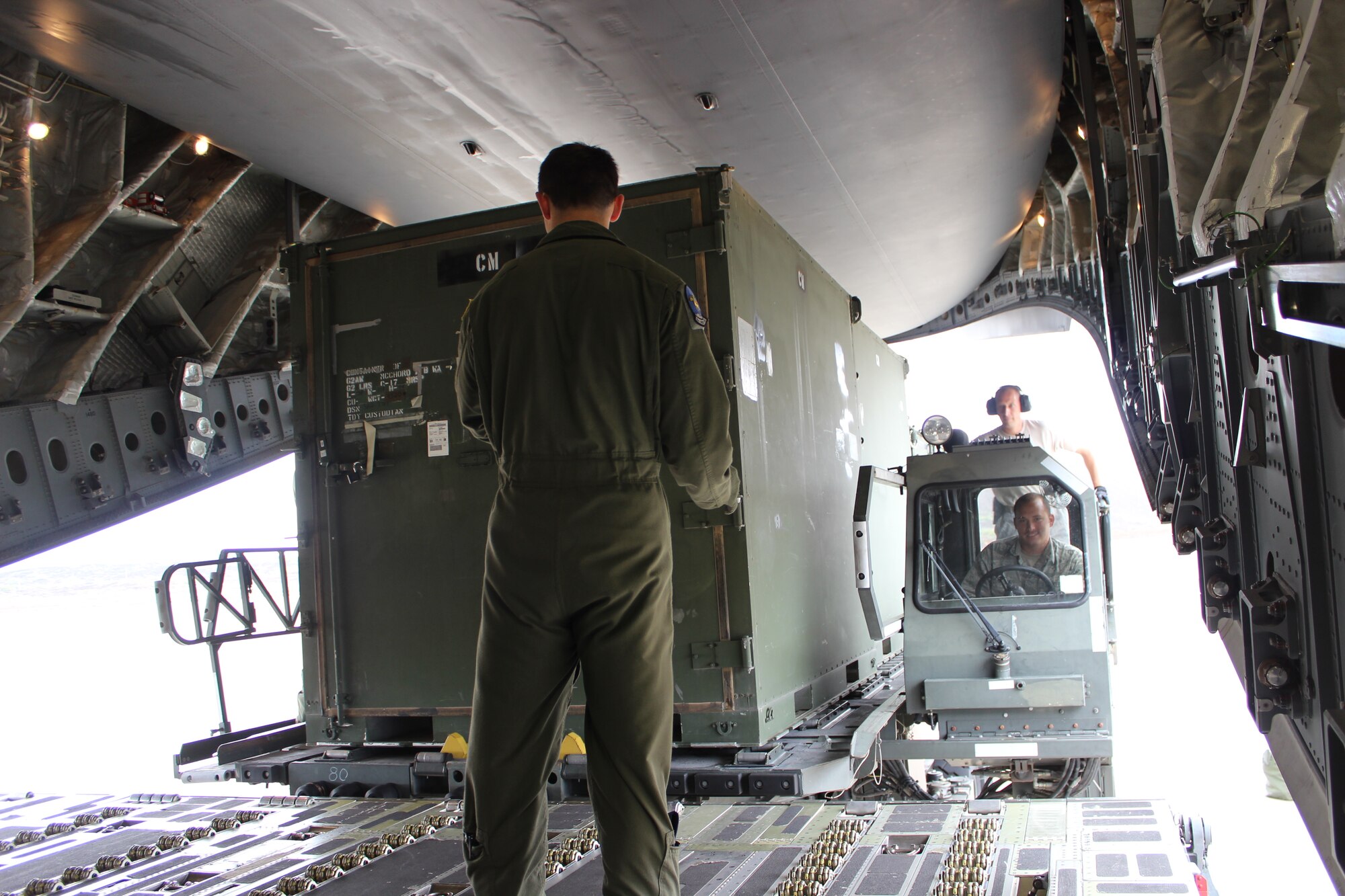 621st Contingency Response Wing Airmen load cargo onto a C-17 Globemaster III at the Ascension Auxiliary Airfield Ramp at Ascension Island in the Southern Atlantic Ocean, June 28, 2013.The normally tranquil island transformed into a major military aircraft hub during the month-long operation moving equipment and passengers to and from Africa in preparation for President Barack Obama’s official state visit to the African continent. (U.S. Air Force photo by Staff Sgt. Sean Baber)