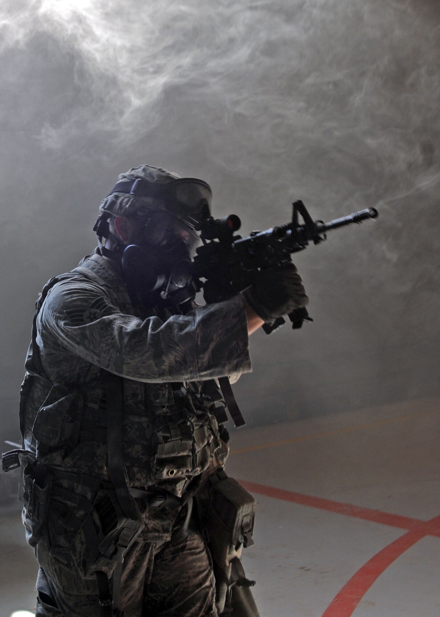 Senior Airman Walter Durston, 39th Security Forces Squadron patrolman, advances through a protected aircraft shelter during an exercise July 24, 2013, at Incirlik Air Base, Turkey. Exercises give Airmen the opportunity to hone their skills in a simulated emergency environment as well as find ways to improve response procedures. (U.S. Air Force photo by Senior Airman Chase Hedrick/Released)