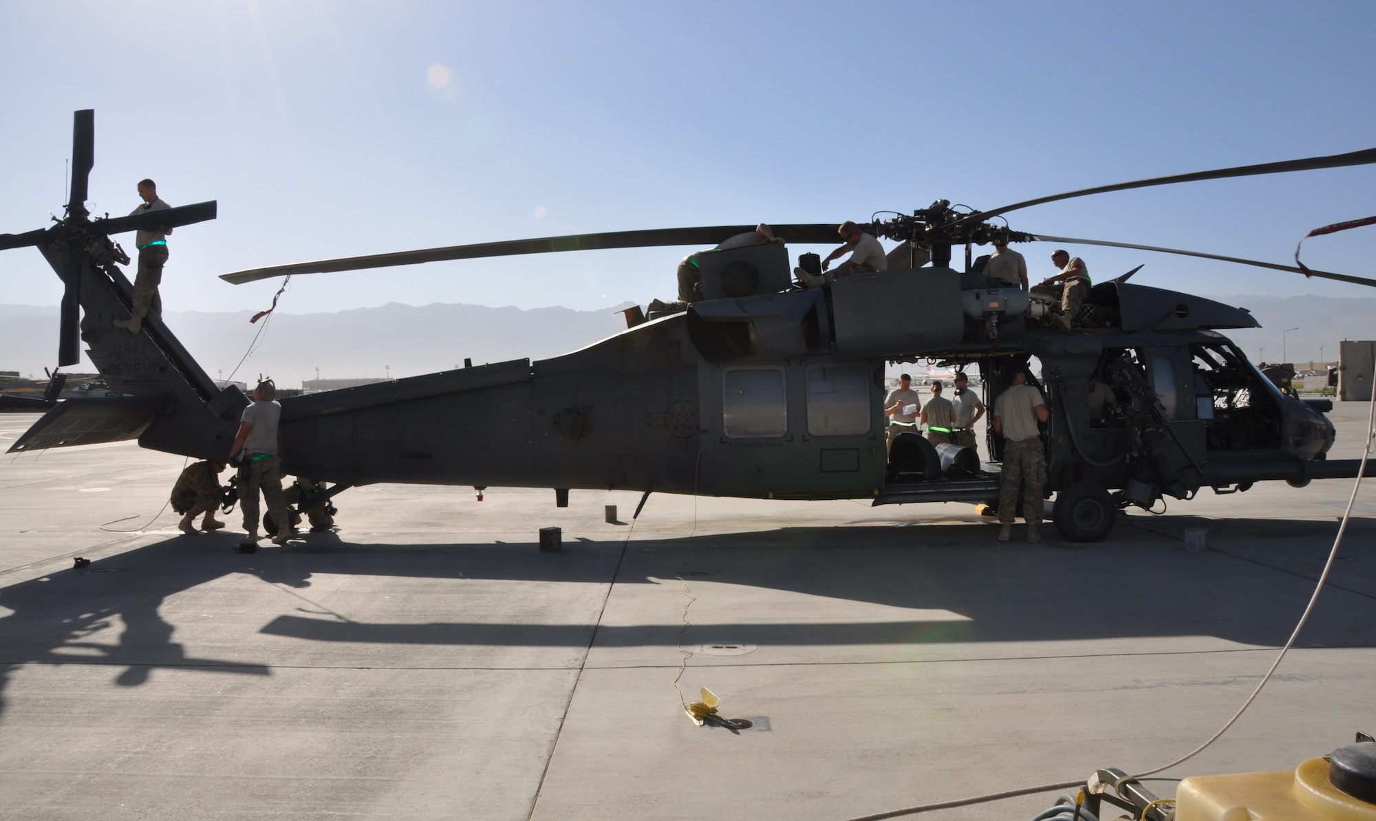 Service members from the 455th Expeditionary Maintenance Squadron conduct a 50-hour preventative maintenance inspection on aircraft 89-6205, an HH-60G Pave Hawk helicopter assigned to the 56th Expeditionary Helicopter Maintenance Unit at Bagram Airfield, Afghanistan, July 24, 2013. The Airmen, are deployed from the 748th Aircraft Maintenance Squadron at Royal Air Force Lakenheath, England. (U.S. Air Force photo/Tech. Sgt. Rob Hazelett)