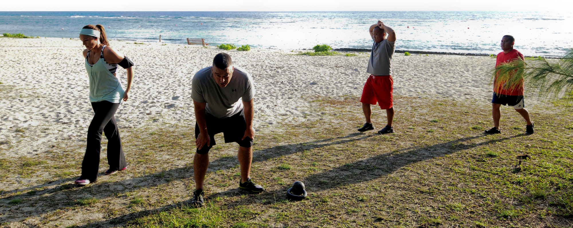 Members of Team Andersen take a break during a Guamfit group workout July 25, 2013, at Tarague Beach on Andersen Air Force Base, Guam. Guamfit is designed to include variety and functional movements in fitness training, as well as teach a person’s body to function properly and maximize performance.  (U.S. Air Force photo by Airman 1st Class Mariah Haddenham/Released)