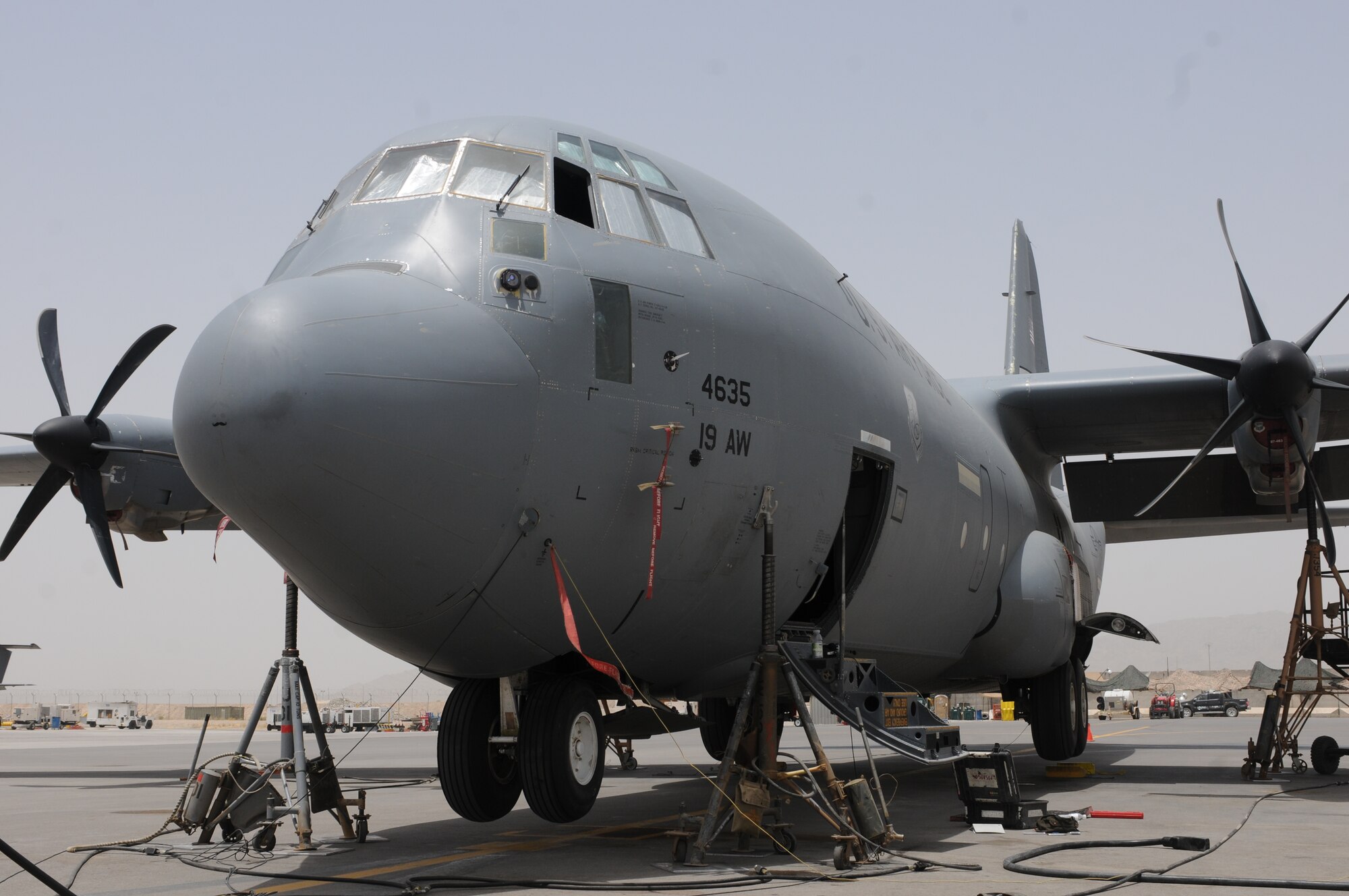 A C-130J Super Hercules is suspended by jacks at Kandahar Airfield, Afghanistan, July 17, 2013. Airmen with the 451st Expeditionary Aircraft Maintenance Squadron raised the C-130J on jacks to work on the brake line near the rear landing gear. (U.S. Air Force photo/Capt. Brian Maguire)