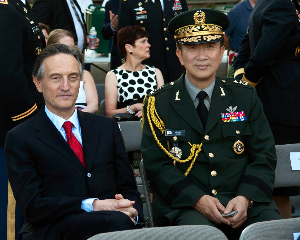 His Excellency Claudio Bisogniero, Ambassador of the Italian Republic to the United States and South Korea Major General Lee, Seo Young, Defense Attaché, wait for the start of the Twilight Tattoo to mark the 60th anniversary of the Korean War and honor the war's veterans on Joint Base Myer-Henderson Hall, Va., July, 24, 2013.