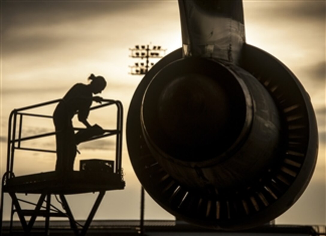 U.S. Air Force Tech. Sgt. Laura Moseley performs an engine check on a C-5 Galaxy aircraft at Joint Base Charleston, S.C., on July 22, 2013.  Moseley is a C-5 Galaxy aircraft crew chief assigned to the 167th Maintenance Squadron, West Virginia Air National Guard.  