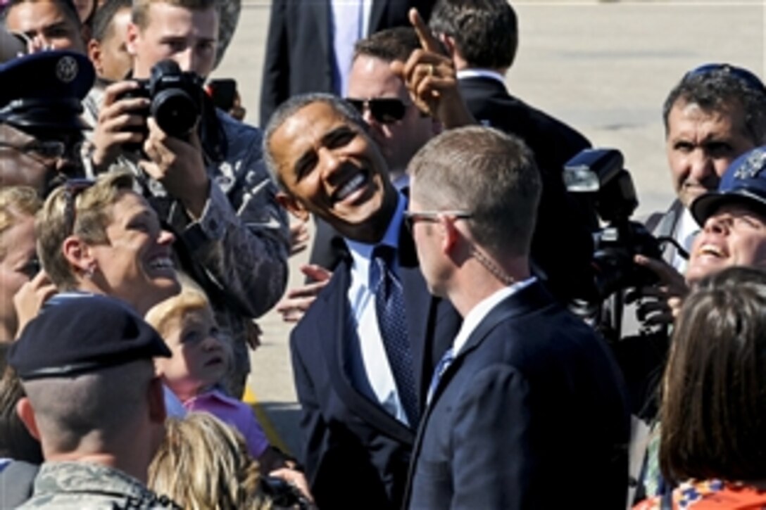 President Barack Obama shares a humorous moment with airmen on Whiteman Air Force Base, Mo., July 24, 2013. The president had reached up and grabbed a boom microphone hovering over a child’s head. 