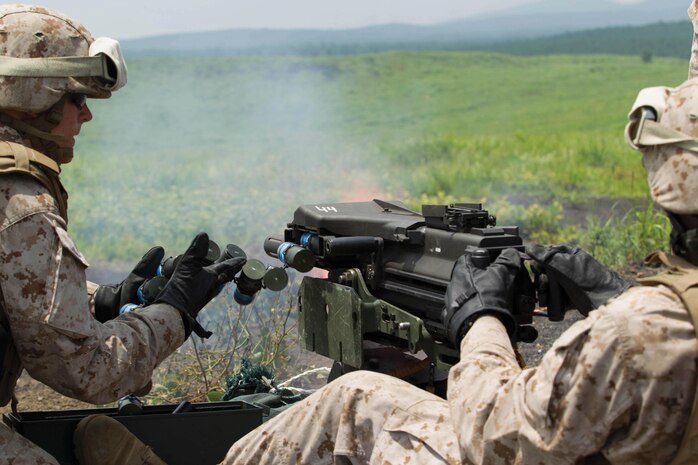 Lance Cpl. Brandon T. Pickens, right, fires a MK19 40 mm automatic grenade launcher July 11 at Combined Arms Training Center Camp Fuji, Japan, during the biannual Fuji Warrior training exercise. The purpose of the exercise is to familiarize Marines with weapons systems and combat tactics in order to build their confidence. Pickens is a landing support specialist with Landing Support Company, Combat Logistics Regiment 37, 3rd Marine Logistics Group, III Marine Expeditionary Force.




