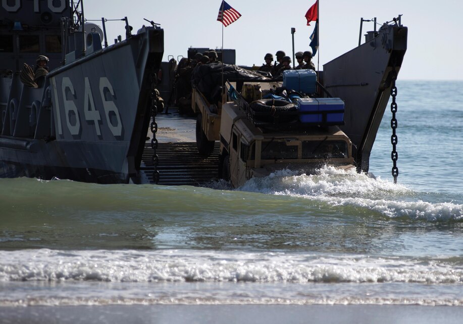 A Humvee takes to the beach from a utility landing craft July 20 during exercise Talisman Saber 2013. Talisman Saber is a biennial exercise that enhances multilateral collaboration between U.S. and Australia forces for future combined operations and humanitarian assistance and disaster relief response. The landing craft is operating in support of the USS Germantown, which is on patrol with the Bonhomme Richard Expeditionary Strike Group with the embarked 31st Marine Expeditionary Unit. Photo by Petty Officer 3rd Class Christopher Lindahl