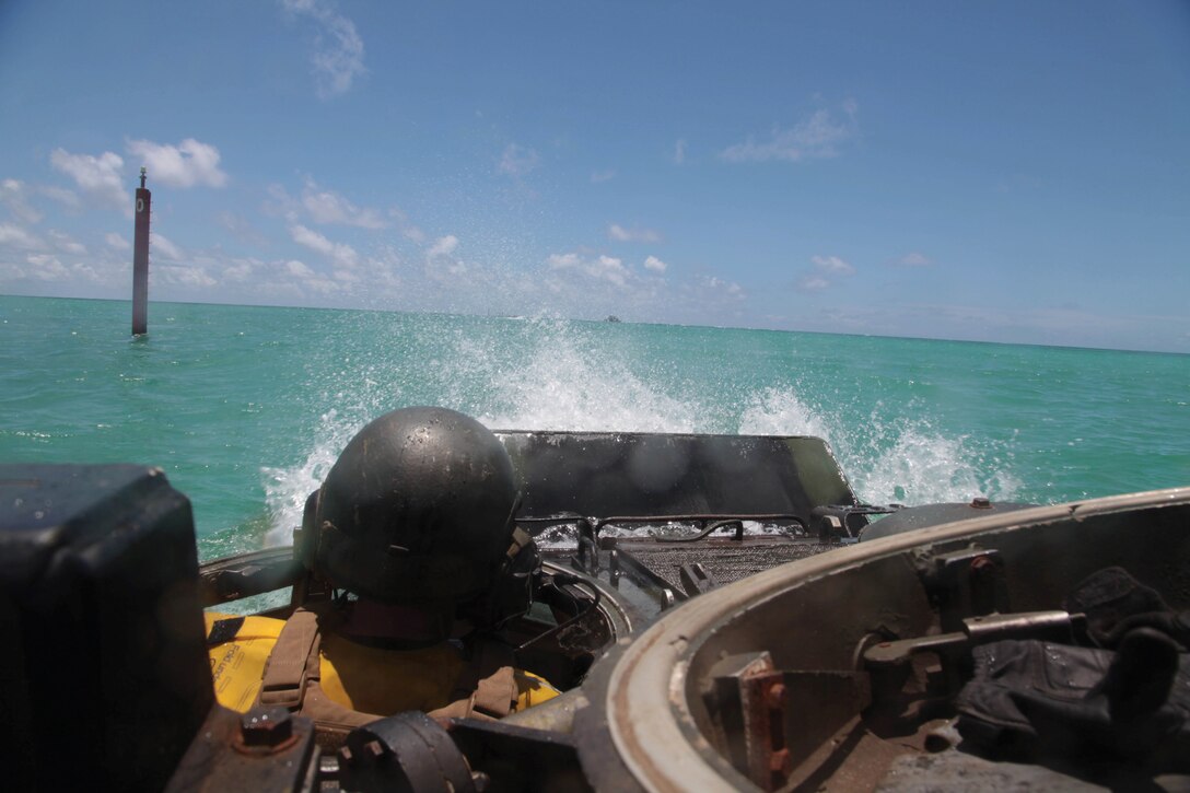 Lance Cpl. Zachary A. Chastain operates an assault amphibious vehicle during a training exercise July 15 near Camp Schwab. CAB provides 3rd Marine Division with engineers, assault amphibious vehicle support, and light-armored reconnaissance, motor transportation, heavy-equipment and communications capabilities, as well as, chemical, biological, radiological and nuclear defense assets all within one unit. Chastain is an assault amphibious vehicle crewman with AAV Company, CAB, 3rd Marine Division, III MEF.