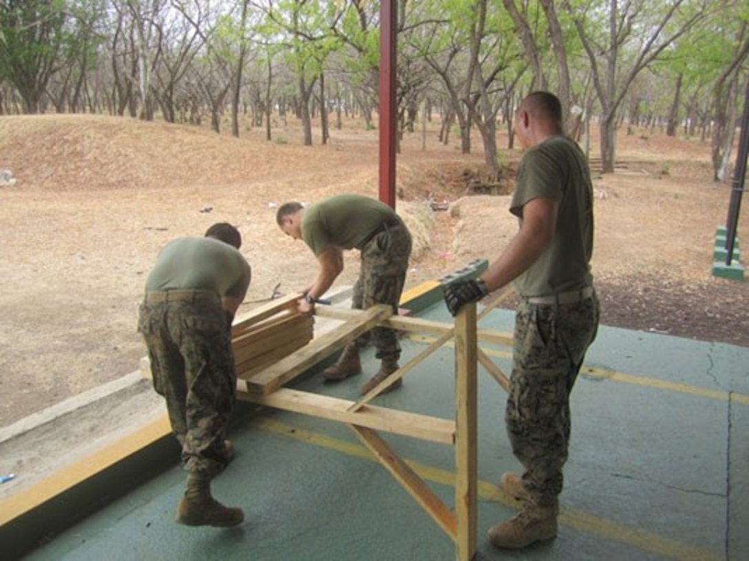Three U.S. Marines with Marine Forces South’s Security Cooperation Team build targets for upcoming marksmanship training from Tropa Naval Nicaragua, May 21.  The Security Cooperation Team trained 24 Marines from Tropa Naval Nicaragua from May 18 through June 9 in a variety of military classes , including human rights, first aid, small-unit leadership, and weapon-systems marksmanship. (Official Marine Corps photo: Courtesy//Released)