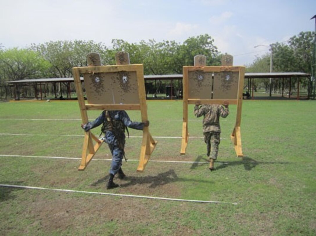 Marines from U.S. Marine Corps Forces South’s Security Cooperation Team and Tropa Naval Nicaragua carry targets back to their staging point after marksmanship training, June 4.  The Security Cooperation Team trained 24 Marines from Tropa Naval Nicaragua from May 18 through June 9 in a variety of military classes , including human rights, first aid, small-unit leadership, and weapon-systems marksmanship. (Official Marine Corps photo: Courtesy//Released