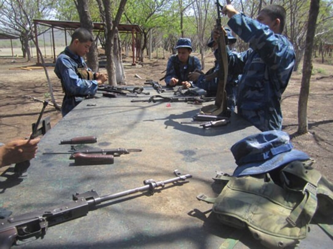 Marines from Tropa Naval Nicaragua clean their weapons after marksmanship training, June 5.  Twenty-four Marines from Tropa Naval Nicaragua participated in training administered by U.S. Marine Corps Forces South’s Security Cooperation Team.  The Security Cooperation Team conducted a variety of classes, including human rights, first aid, small-unit leadership, and weapon-systems marksmanship. (Official Marine Corps photo: Courtesy//Released)