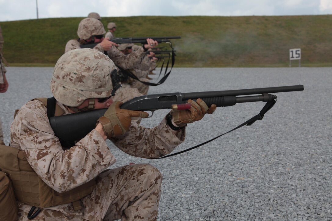 Lance Cpl. Michael B. Luce fires the Mossberg 500 shotgun July 18 during a live-fire training event at Range 18 in the Central Training Area near Camp Hansen. Military policemen with 3rd Law Enforcement Battalion improved their close-range and rapid target-engagement abilities with the shotgun. Luce is a military policeman with Company B, 3rd LE Bn., III Marine Expeditionary Force Headquarters Group, III MEF. Photo by Lance Cpl. Brandon C. Suhr