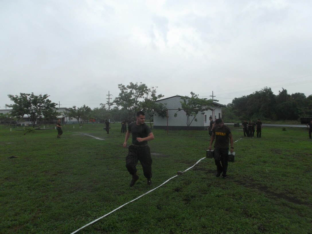 U.S. Marine Cops Lance Cpl. Jonathan Guilbeau, a member of U.S. Marine Corps Forces South’s Security Cooperation Team, runs alongside a member of Guatemala’s Fuerzas Especiales Naval to motivate him during the movement-to-contact portion of the Combat Fitness Test.  The Security Cooperation Team trained members of the FEN in a variety of military classes , including human rights, first aid, small-unit leadership, and weapon-systems marksmanship. (Official Marine Corps photo: Courtesy//Released)
