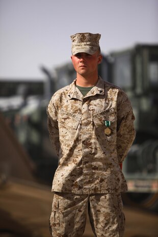 Lance Cpl. Joel T. Murray, a Hallsville, Texas, native and engineer heavy equipment operator with Combat Logistics Company, Combat Logistics Regiment 2, Regional Command (Southwest), stands after receiving the Navy and Marine Corps Commendation Medal with "V" device during a ceremony at Camp Leatherneck, Afghanistan, July 23, 2013. Murray's actions during an attack on a forward operating base helped save the lives of two wounded Georgian soldiers and repel an insurgent assault. 