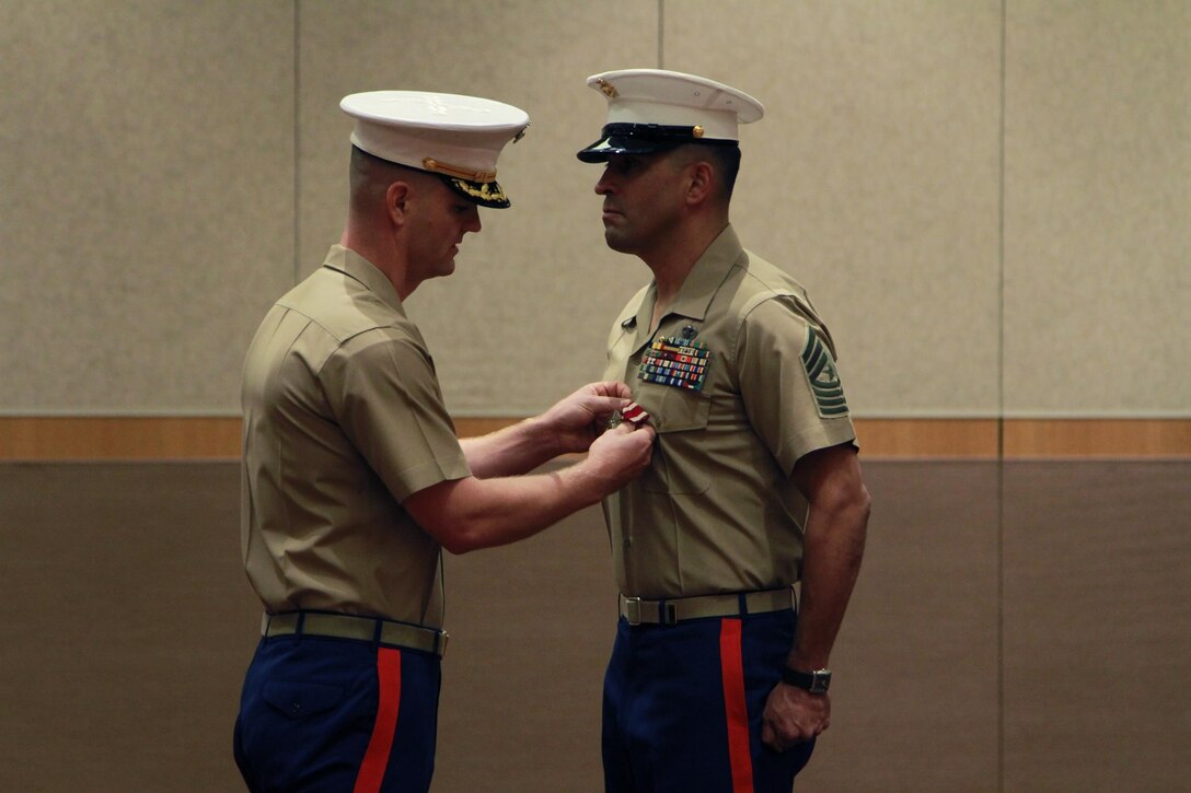 Maj. Matthew L. Hager, commanding officer of Recruiting Station Detroit, awards a Meritorious Service Medal to Sgt. Maj. Alfonso D. Via during a relief and appointmentn ceremony, July 19. Sgt. Maj. Alfonso D. Via relinquished command to Sgt. Maj. Adam H. Yakubsin as the RS Detroit's sergeant major.
