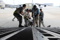 Joint Base McGuire-Dix-Lakehurst airmen load and secure equipment onto aircraft in preparation of Hurricane Irene Aug. 26, 2011. All JB MDL aircraft are being evacuated to Air Force Base's around the country. 