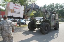 Virginia National Guard soldiers in Sandston prepare for possible duty in response to Hurricane Irene by unloading pallets of cots and Meals Ready to Eat. The Virginia National Guard has been authorized to bring up to 300 personnel on state active duty for possible missions including high water transport and light debris removal. 